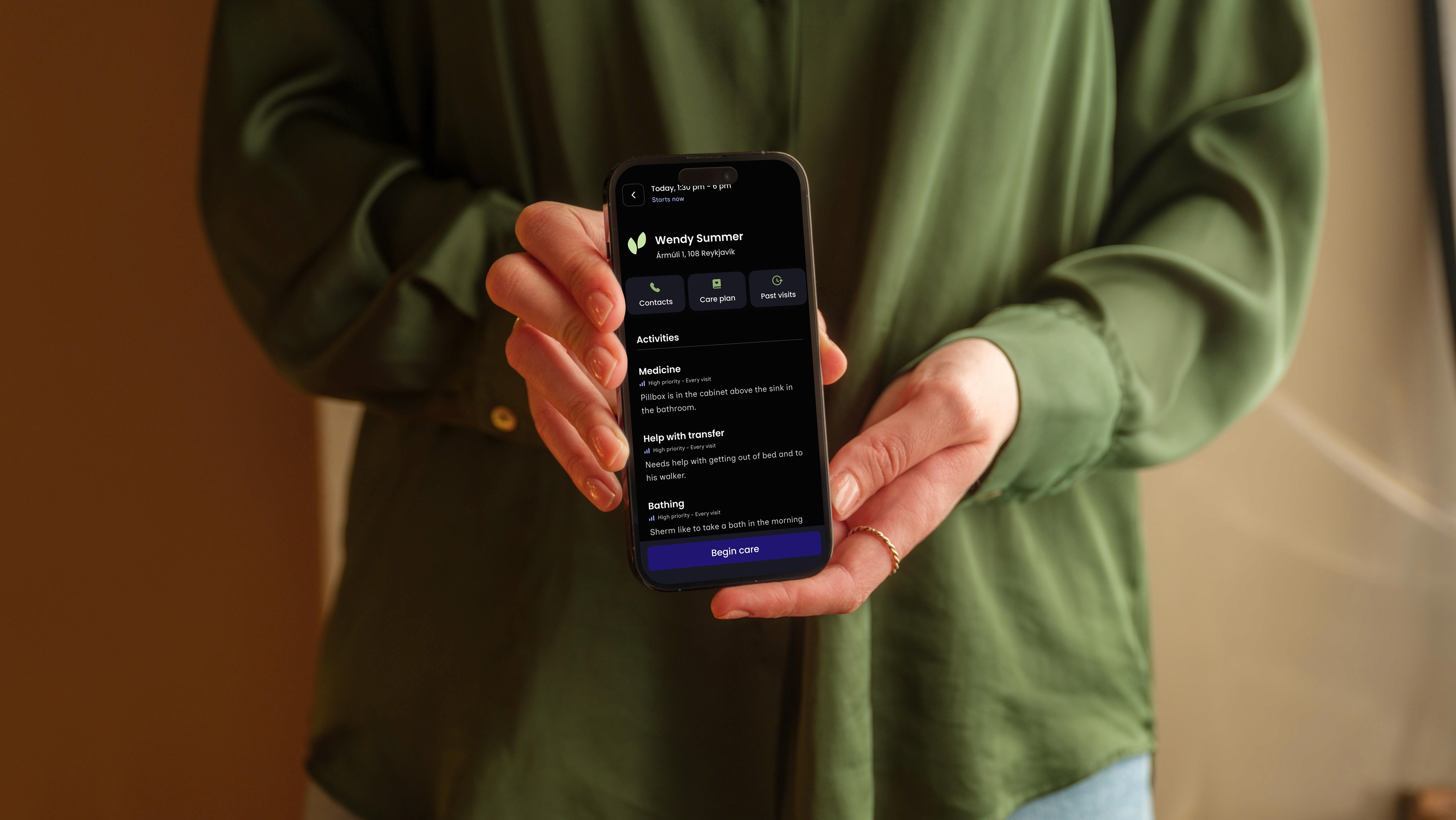 A caregiver holding a phone showing a care recipient's activities in the dala.care app